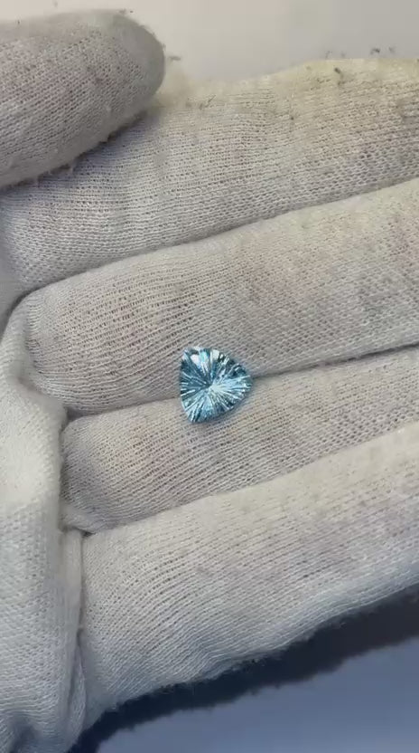 Load video: Natural Blue Topaz Trillion Concave Laser Cut Gemstone